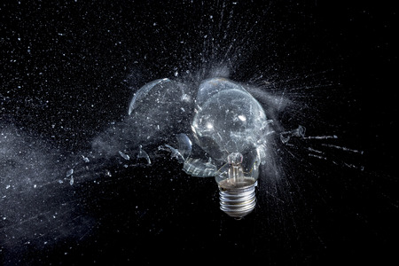 glass bulb explosion on black background