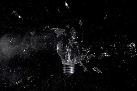 glass bulb explosion on black background