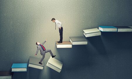 3d books stair falling down and business peopleの写真素材
