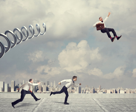 business challenge, businessman take advantage using huge metal spring