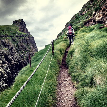 woman hiking on mykines faroe islandsの写真素材