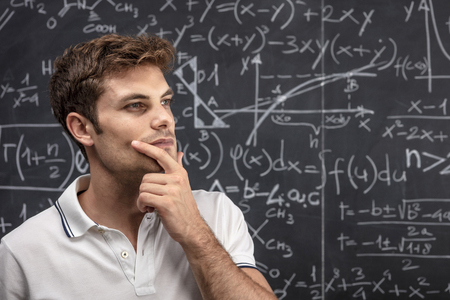 portrait of caucasian student and blackboard background