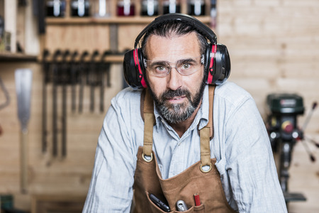 caucasian carpenter at work in a workshop
