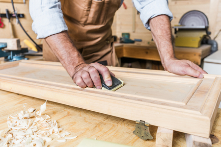 detail of caucasian carpenter at work in a workshopの写真素材