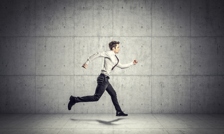 Portrait of young running businessmanの写真素材
