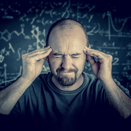 Stressed teacher and blackboard backgroundの写真素材