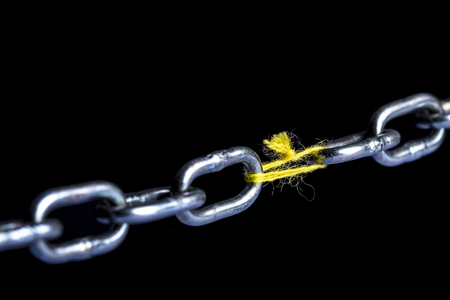 metal chain joint with yarn wire on black backgroundの写真素材