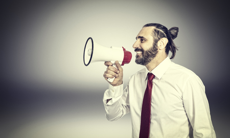 friendly businessman with megaphone portraitの写真素材