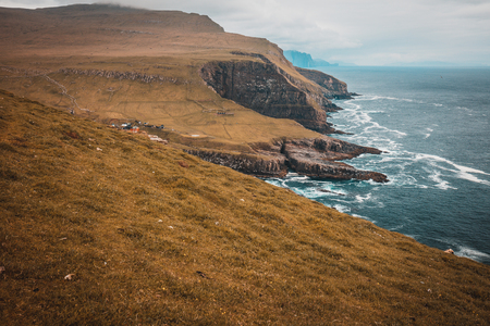 View of the cliffs and the village on the island of Mykines, Faroe.の写真素材