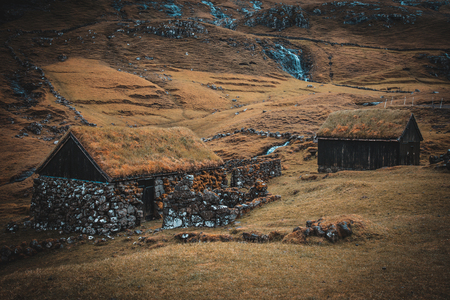 Houses with grass roofs in the village of Saksun on the Faroe Islands.の写真素材