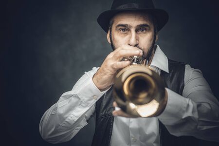 jazz trumpet player on a dark background. Portrait performed in the studio