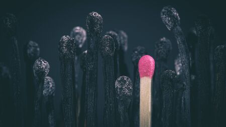 burnt matches and match still intact. Concept of uniqueness, stress, differences, imminent danger, contagion. nobody around.の写真素材