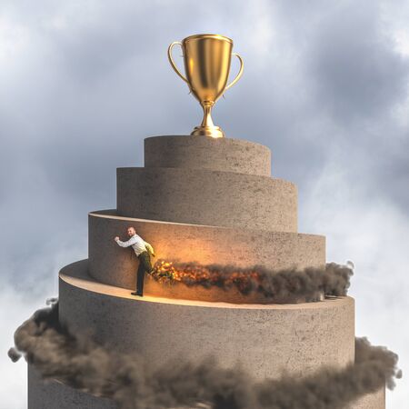 businessman runs to reach the top of the tower where there is a large golden trophy. flames and smoke. concept of determination, victory, leadership and creativity.の写真素材
