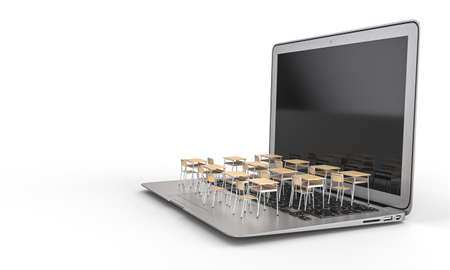 school desks on a laptop keyboard. distance teaching concept due to the covid virus 19の写真素材