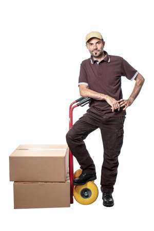 delivery man with handtruck and parcel isolated on whiteの写真素材