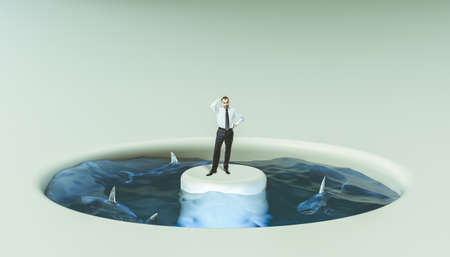 Businessman surrounded by water and sharks. concept of problems and risks at work.の写真素材