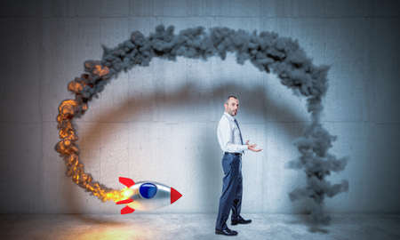 businessman launches a rocket but fails. crisis and problems concept.の写真素材