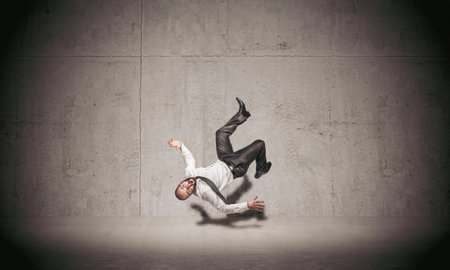 businessman falling on concrete background.