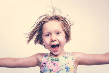 smiling and cheerful little girl with open arms.の写真素材