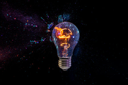 old bulb breaking into fragments on black backgroundの写真素材