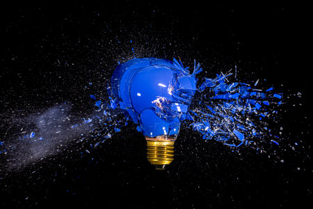 traditional blue bulb breaks and explodes on a black background. high-speed photographyの写真素材