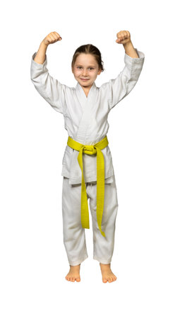 child practicing martial arts wearing a judogi, isolated on whiteの写真素材