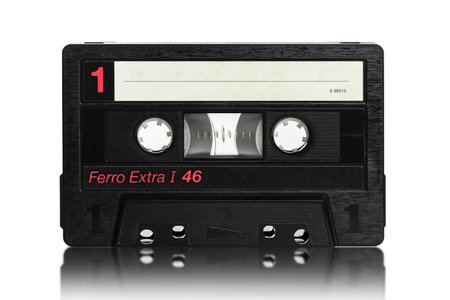 old black audio cassette on a white backgroundの写真素材