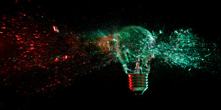 light bulb shattering on black backgroundの写真素材