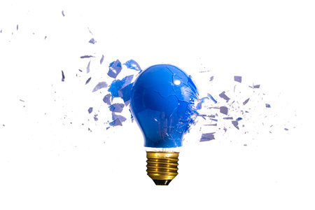 traditional blue light bulb breaks on the white background
