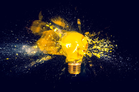 yellow filament bulb destroying on black backgroundの写真素材