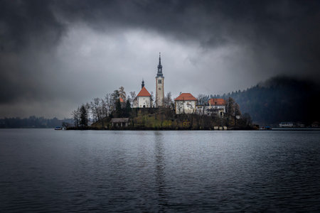 lake bled in slovenia, island with church on a rainy dayの写真素材