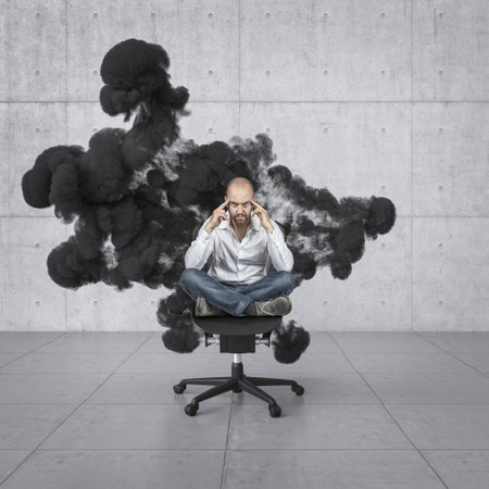 businessman in a chair with black smoke behind him. modern concrete backgroundの写真素材