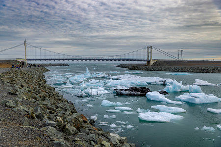 jokulsarlon glacier lagoon floating icebergs bridge in the background, iceland
