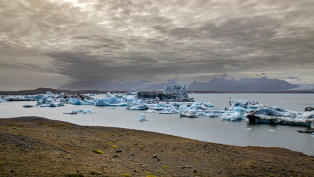 Icebergs floating jokulsarlon glacier lagoon iceland moody sky