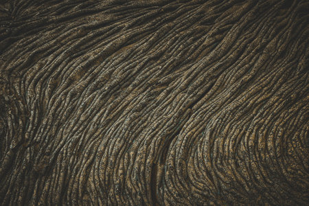 Close up view of solidified lava flowing showing texture and patternsの写真素材