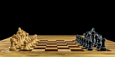 Wooden chess pieces standing on chessboard black backgroundの写真素材