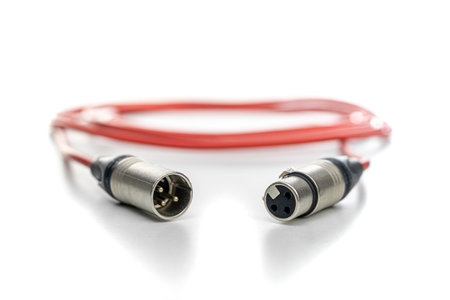Red xlr cable with male and female connectors reflective white surfaceの写真素材