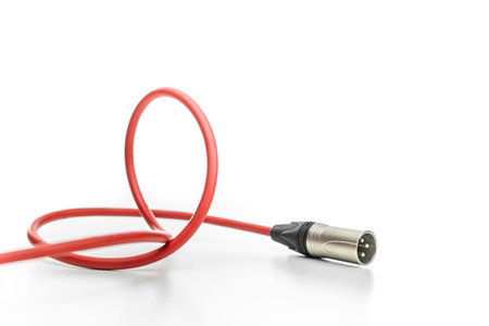 Red audio cable with xlr connector lying white background