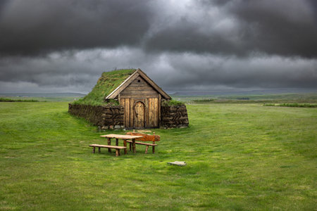 Wooden church house with grass roof in iceland cloudy skyの写真素材