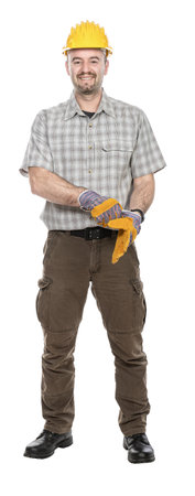 Smiling construction worker putting on work gloves isolatedの写真素材