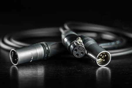 Xlr audio cable lying on dark wooden surfaceの写真素材