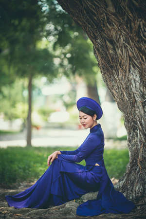 Ho Chi Minh City, Vietnam: Ho Chi Minh City, Vietnam: Portrait women in purple ao dai Vietnam, The Ao dai ( long-dress Vietnamese) is traditional costの写真素材