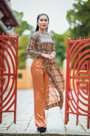 Ho Chi Minh city, Viet Nam: Vietnamese girls wear traditional Ao Dai to go to pagodas