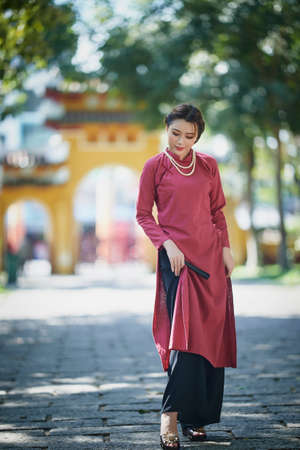 Ho Chi Minh City, Vietnam: Portrait women in pink ao dai Vietnam, The Ao dai ( long-dress...