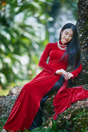 Ho Chi Minh City, Vietnam - March 1, 2021: Portrait of a beautiful girl in a red ao dai