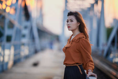 Ho Chi Minh city, Viet Nam: Portrait of a beautiful Vietnamese girl in the sunsetの写真素材