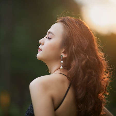 Ho Chi Minh city, Viet Nam: Portrait of a beautiful Vietnamese girl in the sunsetの写真素材