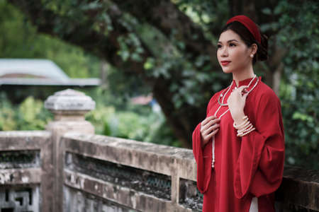 Ho Chi Minh city, Viet Nam: Vietnamese girl going to pagoda in ao daiの写真素材
