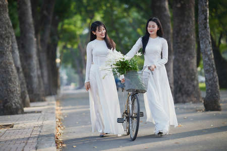 Ho Chi Minh City, Vietnam: The beautiful and pure friendship of two Vietnamese schoolgirls in white...