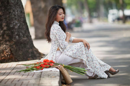 Ho Chi Minh city, Viet Nam: Portrait of a Vietnamese girl wearing a traditional Ao Dai